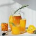 raw sea buckthorn and orange juice in glasses with rosemary antioxidant drinkfor immunity boost in spring vitamin juice for healthy life