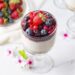 Milky sweet delicious pudding topped with forest fruits and fru